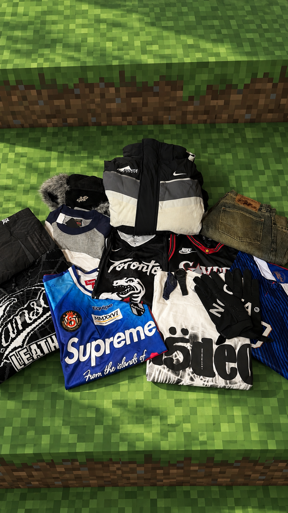 Winter haul laid out with a black and cream jacket, jerseys, jeans and gloves, posted by Reddit user C0soo